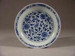 An Imperial Kangxi mark and period blue & white saucer decorated with lotus & tendril design