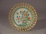 Yongzheng famille rose export plate with central floral spray and interlocking rings painted in a faux marbleized finish