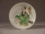 康熙清代 A Small Kangxi Famille Verte Coral Backed Dish Decorated with an Immortal