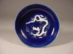 正德 Zhengde mark & period saucer dish covered in a deep blue glaze with applied carved dragons reserved in white biscuit