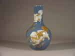 A powder blue ground 乾隆 Qianlong Bottle Vase with carved fu dogs in relief