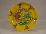 A Kangxi Yellow Saucer Dish with Green and Aubergine Dragons