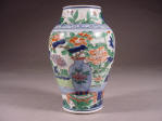 順治 A Shunzhi wucai olive shaped vase decorated with various potted flowering plants